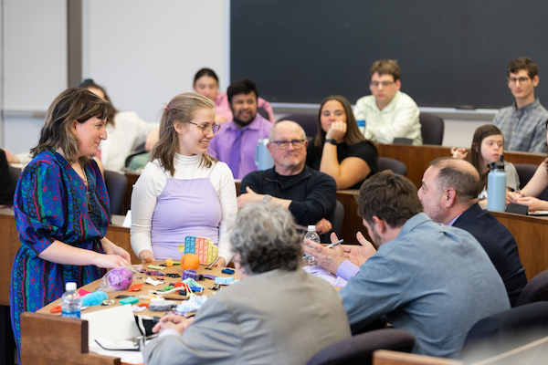 Two Intelligence++ competition participants show a prototype to judges